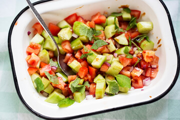 Tomato, cucumber, red onion salad with mint and balsamic vinegar