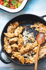 Chicken souvlaki kebabs on pan with rice 