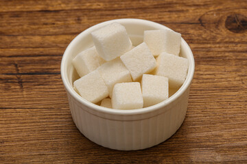 Refined white sugar cubs in the bowl