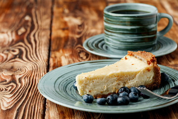 Piece of classic cheesecake on green plate