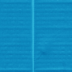 Fototapeta premium A blue vintage rough sheet of carton. Recycled environmentally friendly cardboard paper texture. Simple minimalist papercraft background.