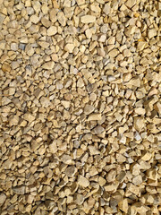 Background of gray gravel. Small stones lie on the ground at a construction site. Pebble pattern on the beach