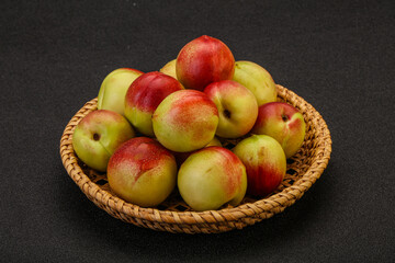 Sweet small nectarines in the basket
