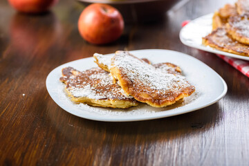 homemade apple pancakes sprinkled with powdered sugar.