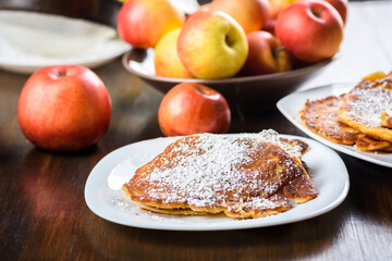 homemade apple pancakes sprinkled with powdered sugar.