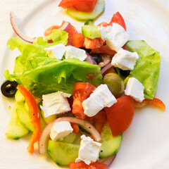 Greek salad on white plate close up