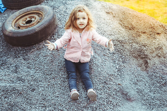 A Girl Plays In A Poor Neighborhood