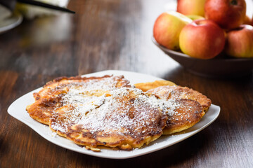 homemade apple pancakes sprinkled with powdered sugar.