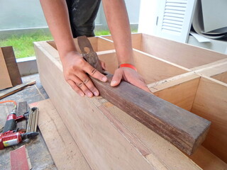  Carpenter are using a router cutting edge smoothing. Carpenters are building furniture.