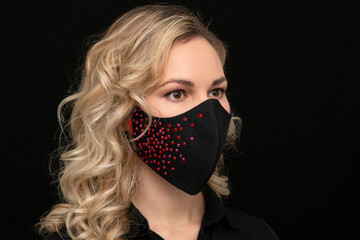 blonde in a stylish medical mask with gems, handmade