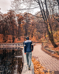 Man walking in the park during fall