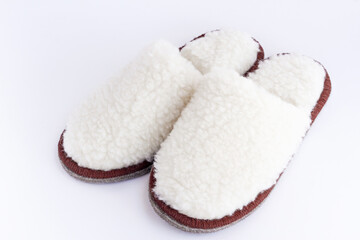 a pair of white home cozy Slippers made of wool on a white background
