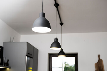 Industrial black look pendant lamps in a kitchen interior. Modern loft interior design.