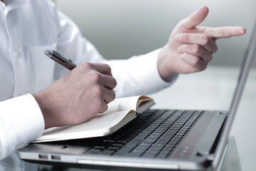 The manager works at the computer in the office