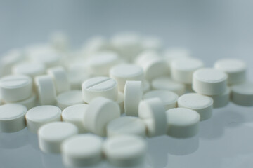 White pills on glass table