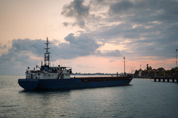 Fototapeta premium Blue cargo ship in port