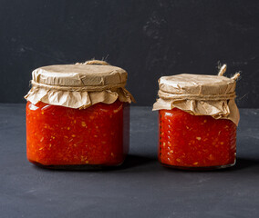 Adjika - spicy aromatic seasoning for meat and fish dishes on dark background