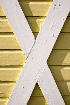Building exterior, wood cladding, cross beams, white and yellow woodwork