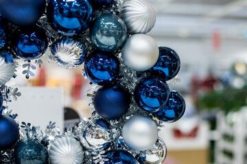 Holiday round frame, silver and blue glass Christmas balls, isolated on blurred background.Happy new year decoration for home. Merry Christmas. Advent Christmas wreath