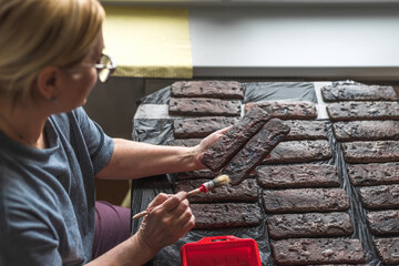 Making and painting decorative bricks at home. Handmade work.