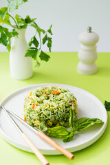 rice with vegetables and pesto sauce, creative image of an Asian dish