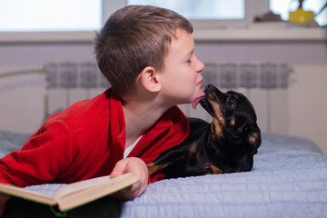 Boy with dog reads a book