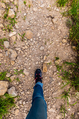 A first-person point of view (POV) of an unrecognizable young female hiker hiking in the French Alps