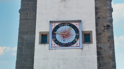 beautiful clock on the granite wall of the ancient fortress tower in the old German town of Dinkelsb&uuml;hl