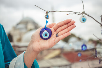 Turkish amulet from the evil eye Nazar on the girls hand