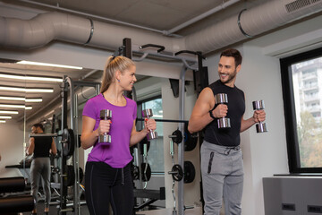 Fototapeta na wymiar Handsome couple workout together in modern gym