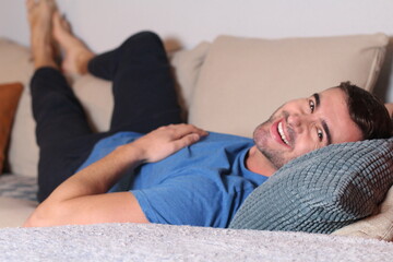 Attractive man enjoying the sofa 