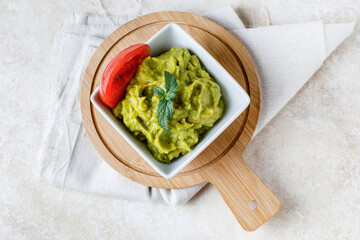 Guacamole sauce with tomato and lemon
