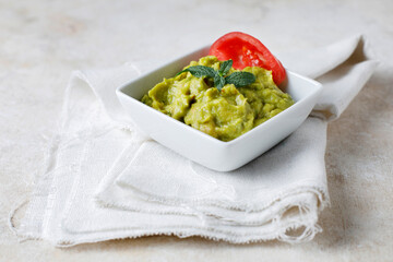 Guacamole sauce with tomato and lemon
