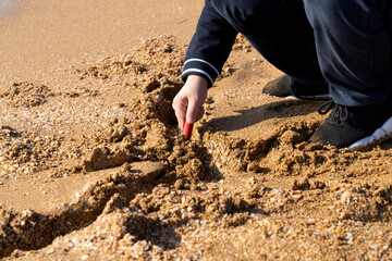 Boy playing with sand on the beach
