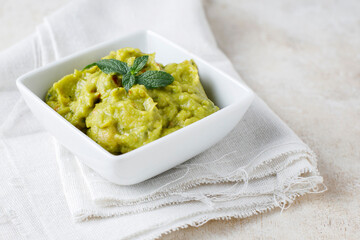 Guacamole sauce with tomato and lemon