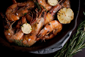 Jumbo shrimp grilled in skillet with rosemary and lemon