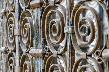  Wrought iron fence. Detail of an old retro iron fence made with decorated ironwork elements. Old and worn, still showing some of its former splendor
