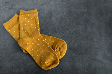 A pair of yellow socks on dark background