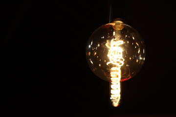 Obraz premium glowing edison lamp in a bar