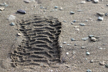 footprint on black volcanic sand