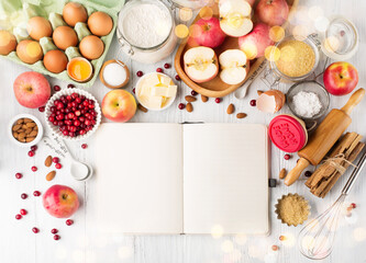 Ingredients for autumn winter baking - flour, sugar, eggs, apples, pumpkins and spices.