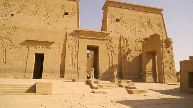 Entrance with beautiful pharaohs in the Temple of Philae without people, Greco-Roman construction seen from the Nile river, temple dedicated to Isis, goddess of love. Aswan. Egyptian