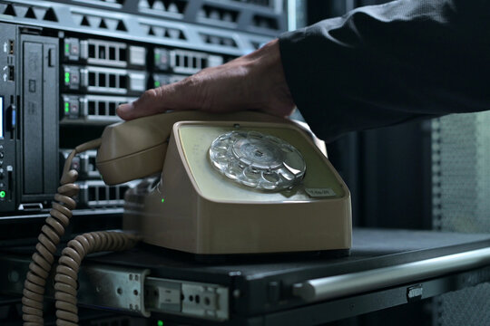 dial phone, which stands against background of a server cabinet
