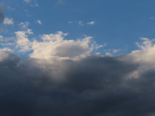 blue sky over dark clouds