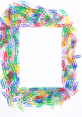 Frame made of colored paper clips on white background,top view with space for text or creativity.Frame