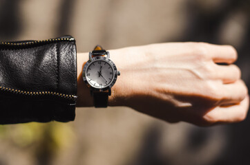 Fashionable watch on a woman's hand. Woman watch time on wrist watch