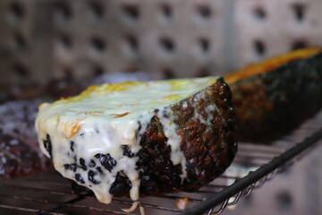 Pumpkin stuffed with cheese baked on the grill.