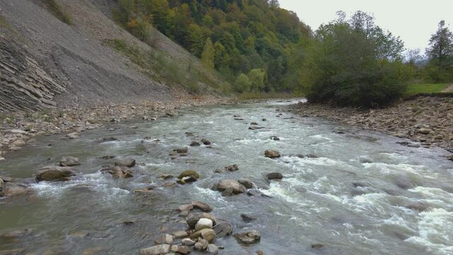 4K Ukraine drone aerial shot of alpine mountain river in hutsul Carpathians, beautiful autumn nature perfection