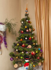 Christmas artificial tree decorated with toys