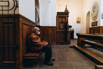 07.06.2020 Vinnitsa, Ukraine: a bald old man in glasses and a protective mask risking his life came to the church for liturgy during a viral epidemic